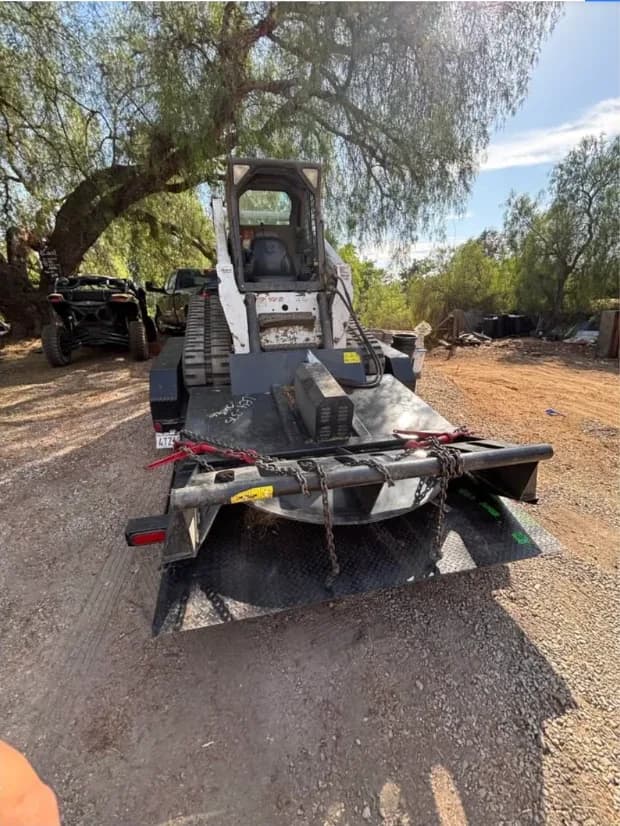 Bobcat T300 compact track loader on the trailer with a brush cutter attachment